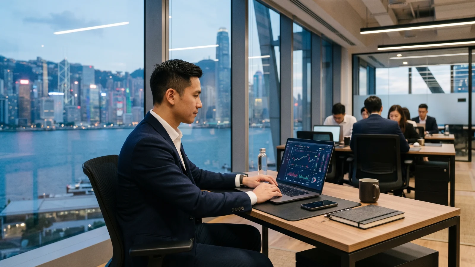 Executive using premium business laptop inside modern Bangkok office with fintech dashboards and AI workflow screens